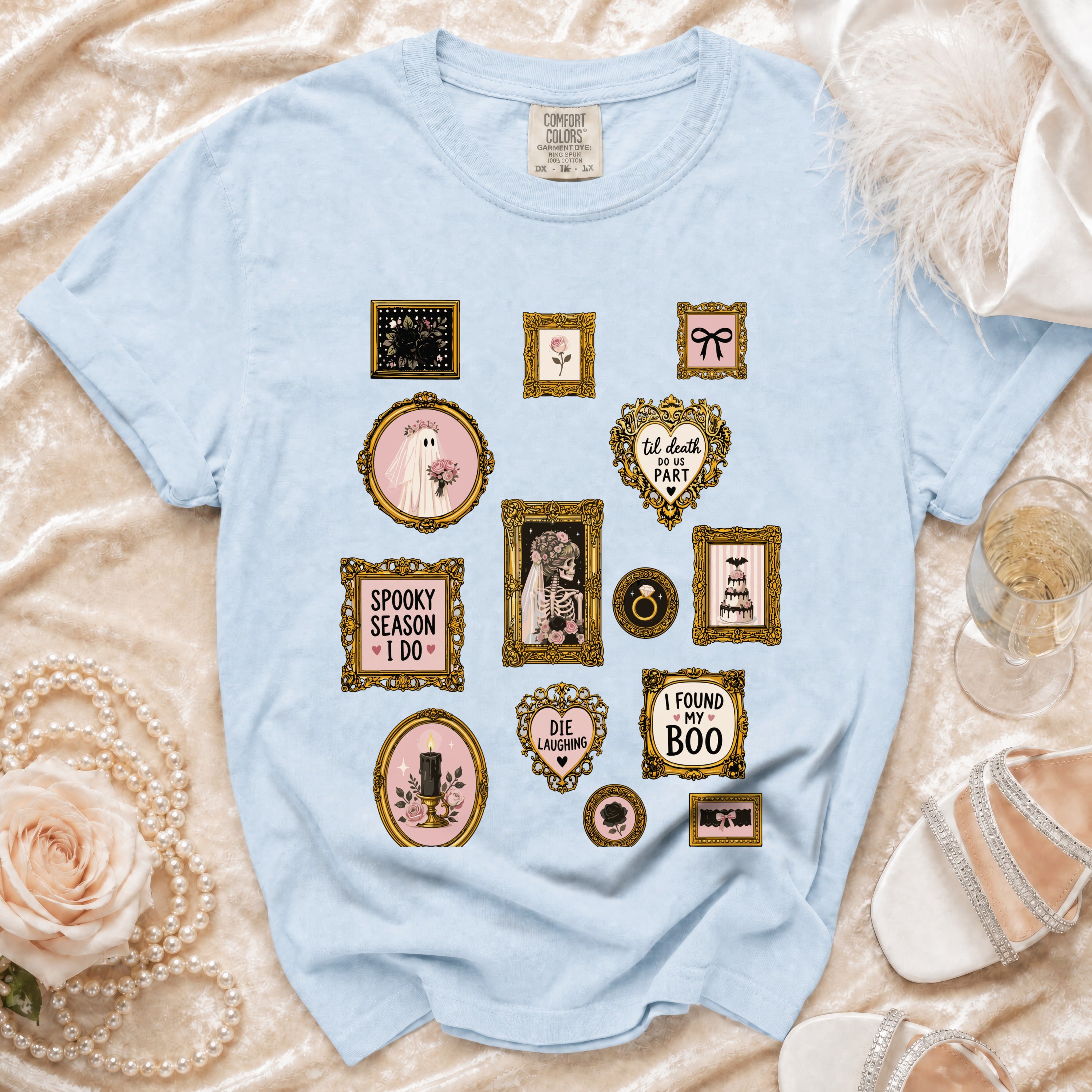 Light blue t-shirt with vintage-style framed graphics of Halloween and spooky themes.