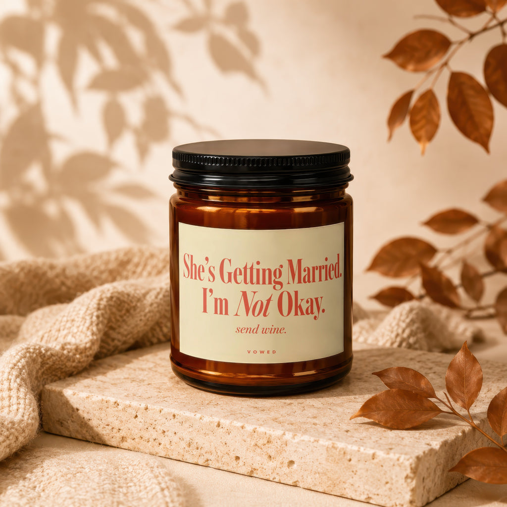 Amber jar candle with black lid reads "She's Getting Married. I'm Not Okay. send wine."