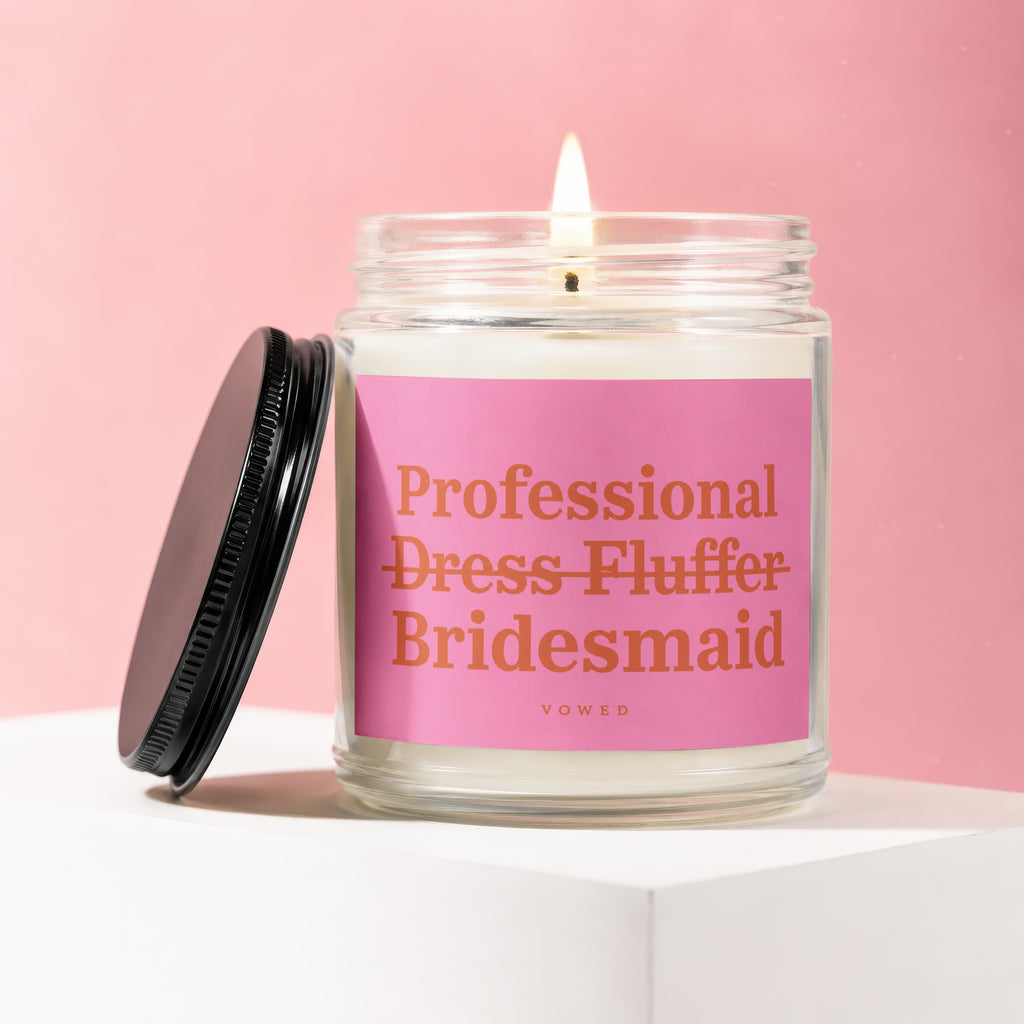 Jar candle with pink label reading "Professional Dress Fluffer Bridesmaid Vowed".