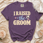 Purple t-shirt with "I RAISED the GROOM" text and floral graphics.