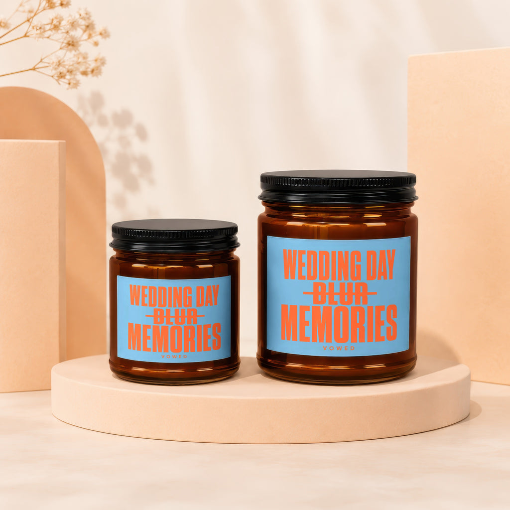 Two amber glass candles with black lids, labeled "Wedding Day Blur Memories".