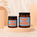 Two amber glass candles with black lids, labeled "Wedding Day Blur Memories".