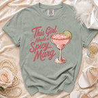 Light green t-shirt with "This Girl Needs a Spicy Marg" and margarita graphic.