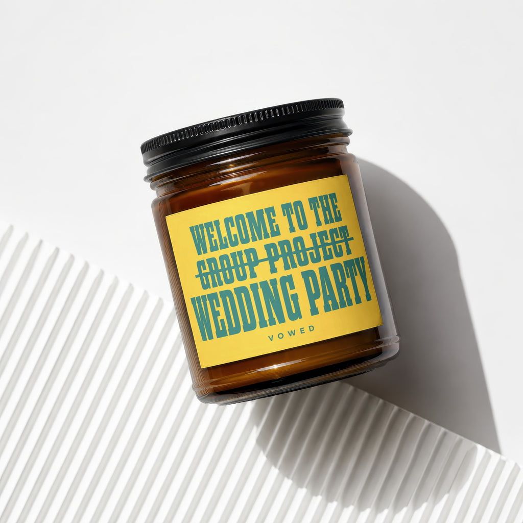 Candle with text "Welcome to the wedding party" on yellow label.