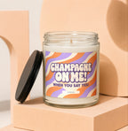 Glass candle with "Champagne On Me! When You Say Yes!" text on wavy label.