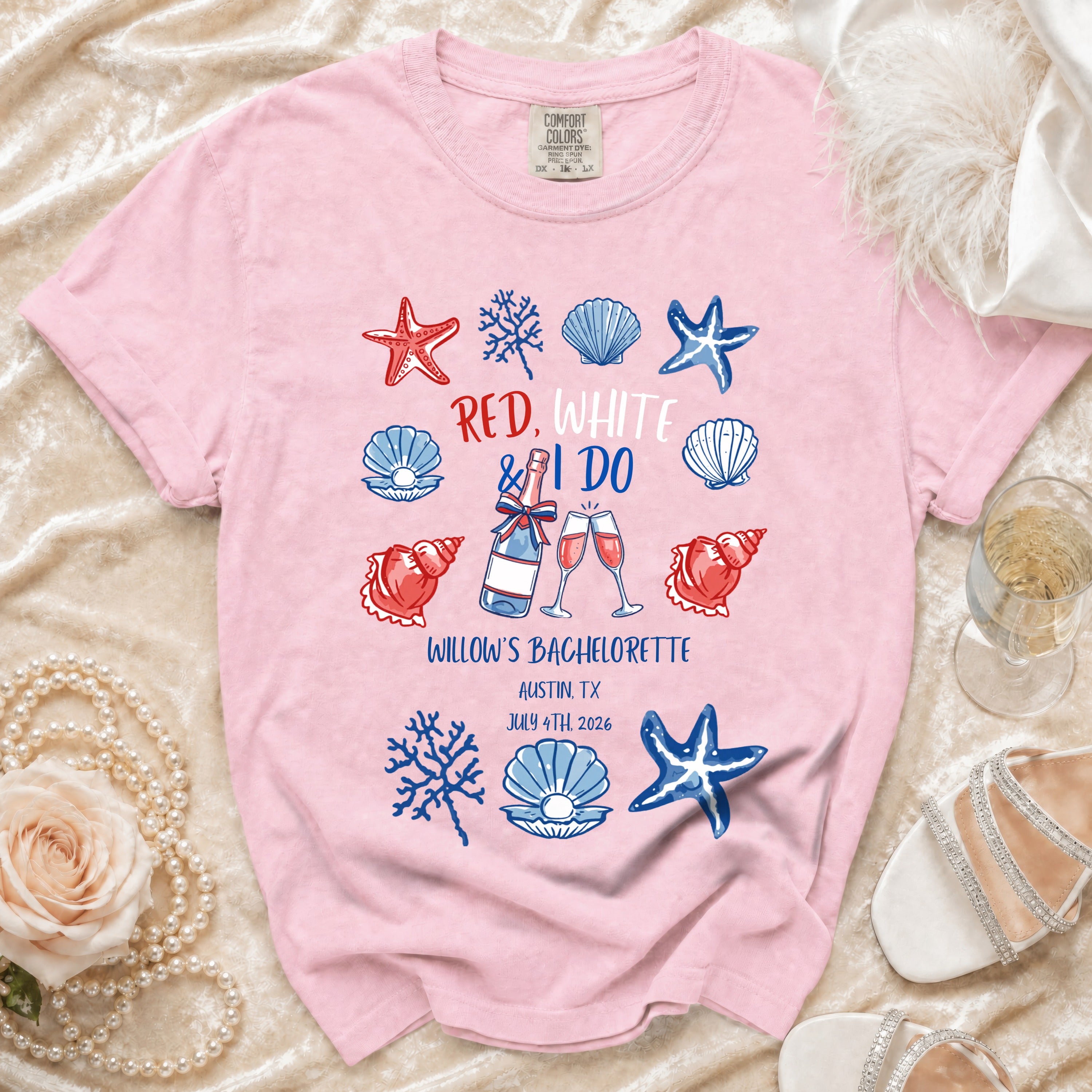 Red, white, and I do text with seashells and starfish on a pink t-shirt.