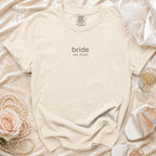 Cream "bride est. 2026" t-shirt with pearls, rose, and shoes.
