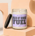 Maid of Honor Fuel candle with lavender label that reads "Apply Liberally."