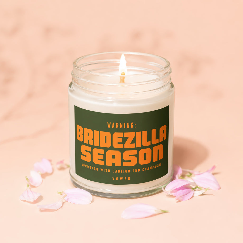 Lit candle with label that reads "Warning: Bridezilla Season. Approach with caution and champagne. Vowed."