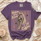 Purple t-shirt with "Mother of the Bride I Do Coffins" graphic on striped background.