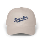 Light beige baseball cap with the blue embroidered text Tipsy in Love across the front.