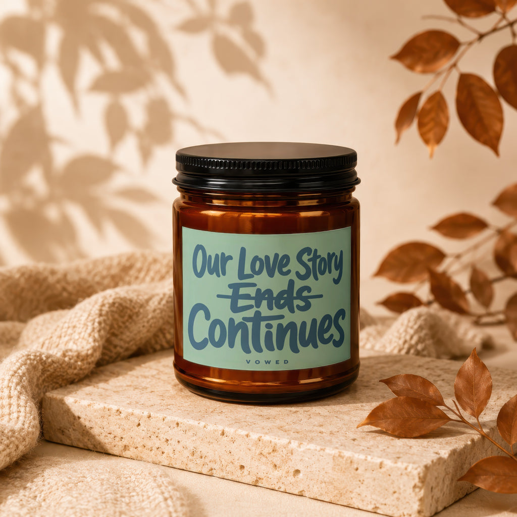 Amber candle with "Our Love Story Ends Continues" text, "vowed" below.