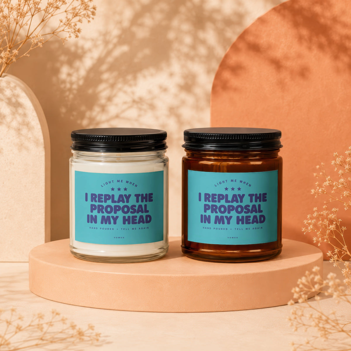 Two candles with teal labels reading "Light me when I replay the proposal in my head."