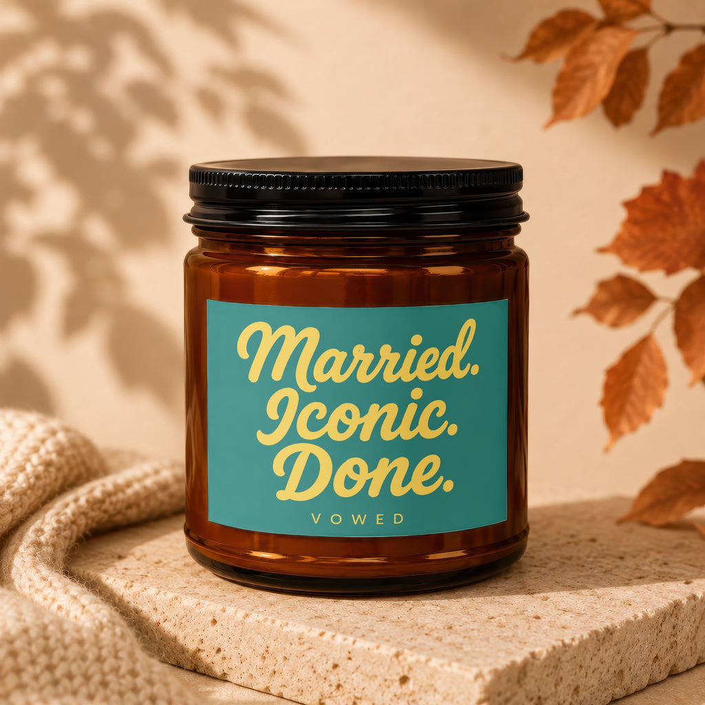 Amber glass candle with teal label reading "Married. Iconic. Done. VOWED."