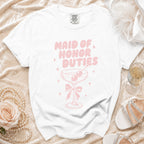 White t-shirt with pink text that reads "MAID OF HONOR DUTIES" and a cocktail glass.