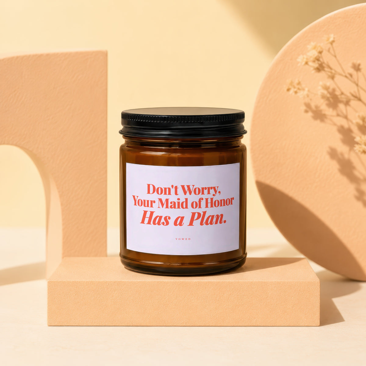Amber candle with black lid, white label saying "Don't Worry, Your Maid of Honor Has a Plan."