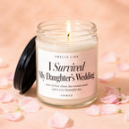 Lit candle in jar with lid off, surrounded by pink petals. Label reads "I Survived My Daughter's Wedding".