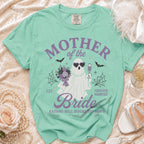 Mint t-shirt with a ghost bride graphic that says "Mother of the Bride," "Forever Haunted," and "Raising Hell Before the Vows."