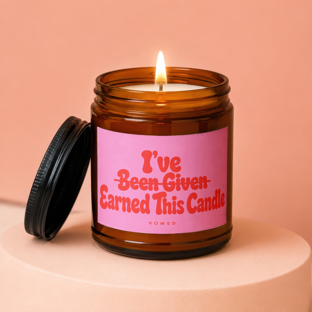 Amber jar candle with pink label reading "I've Earned This Candle".