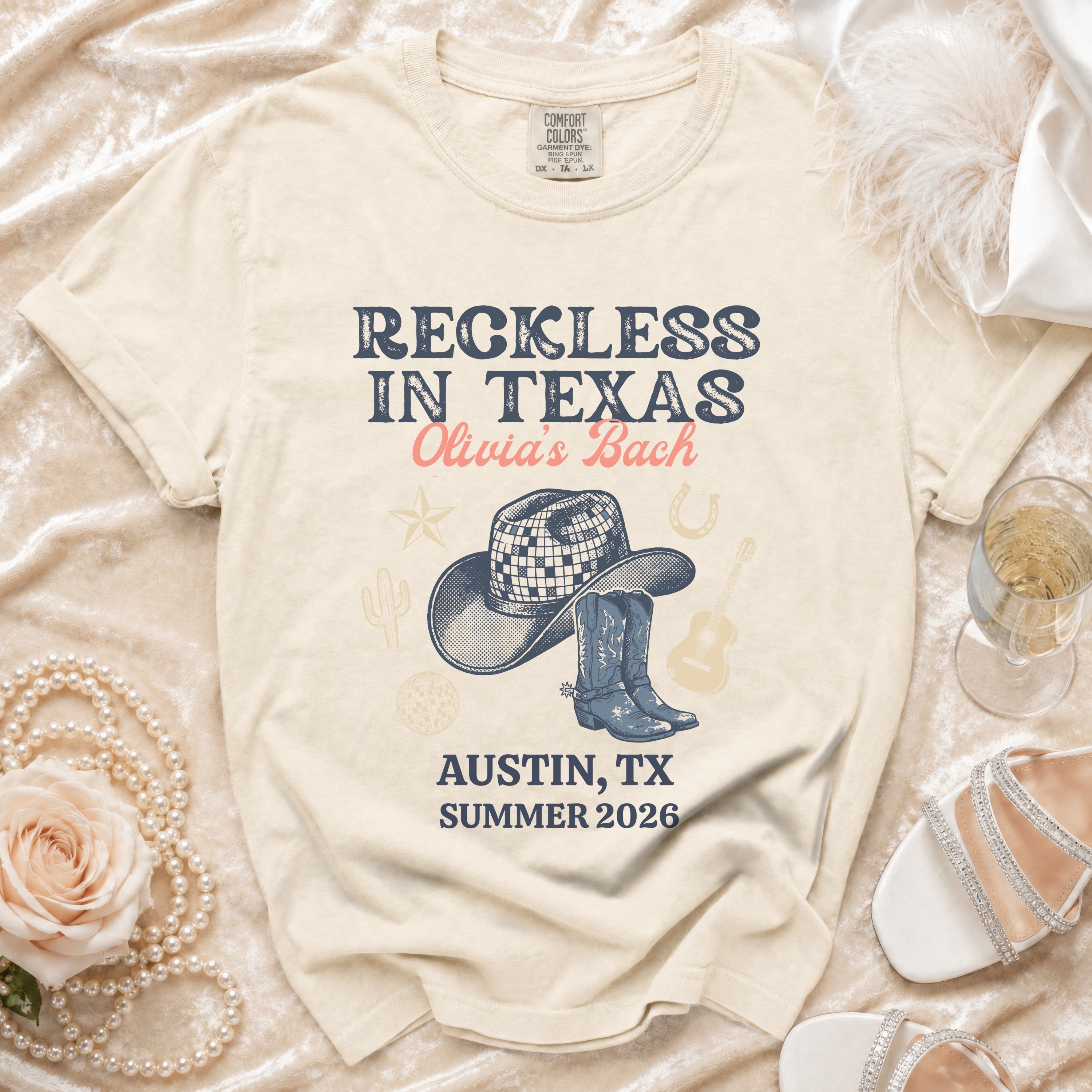 T-shirt with "Reckless in Texas Olivia's Bach Austin, TX Summer 2026" graphic.