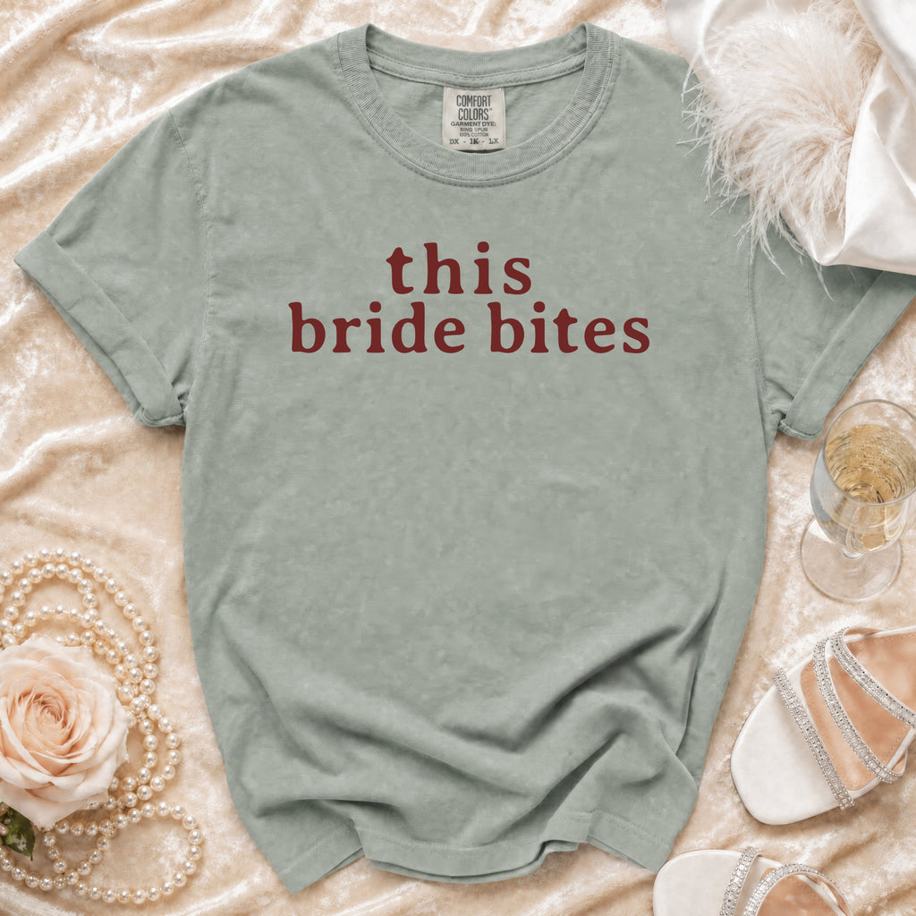 Sage green t-shirt with "this bride bites" text, styled with pearls and heels.