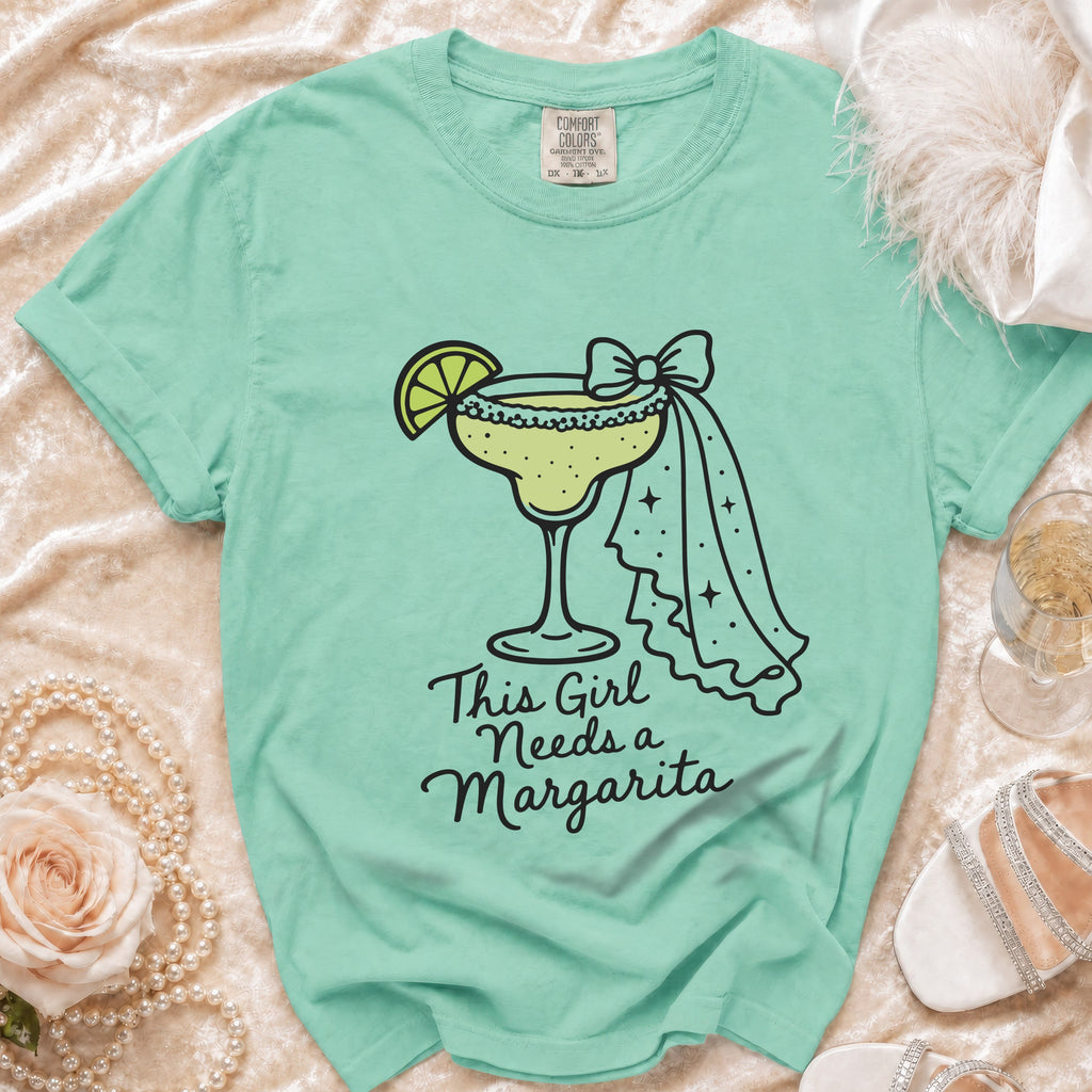 Aqua t-shirt with a margarita graphic and text that says "This Girl Needs a Margarita."