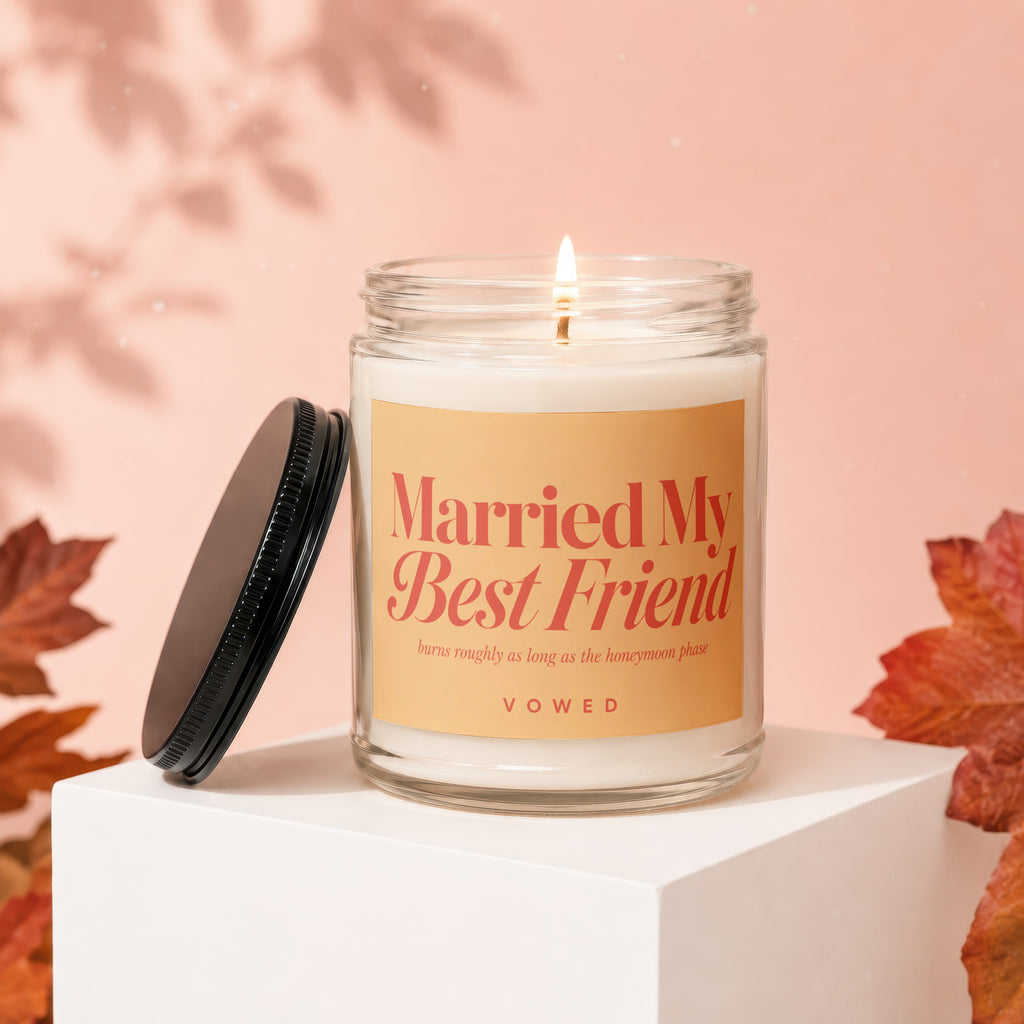 Lit candle with "Married My Best Friend" text and cap beside it.