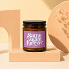 Amber jar candle with purple label reading "Same team forever" and "VOWED."