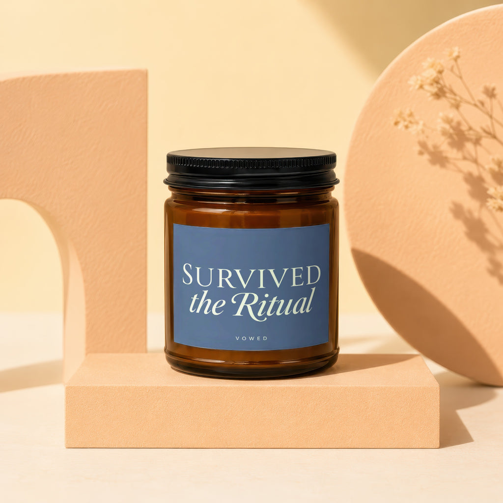 Brown glass candle with label "SURVIVED the Ritual" by VOWED.