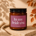 Amber glass candle with pink label that reads "In my bride era. VOWED."