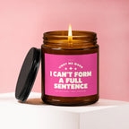 Brown glass candle with pink label reading "I CAN'T FORM A FULL SENTENCE"