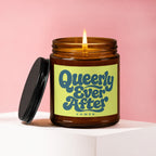 Candle with "Queerly Ever After" text and "VOWED" below, lid removed.