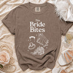Brown t-shirt with "This Bride Bites" text and vampire, ring, veil, and rose graphics.
