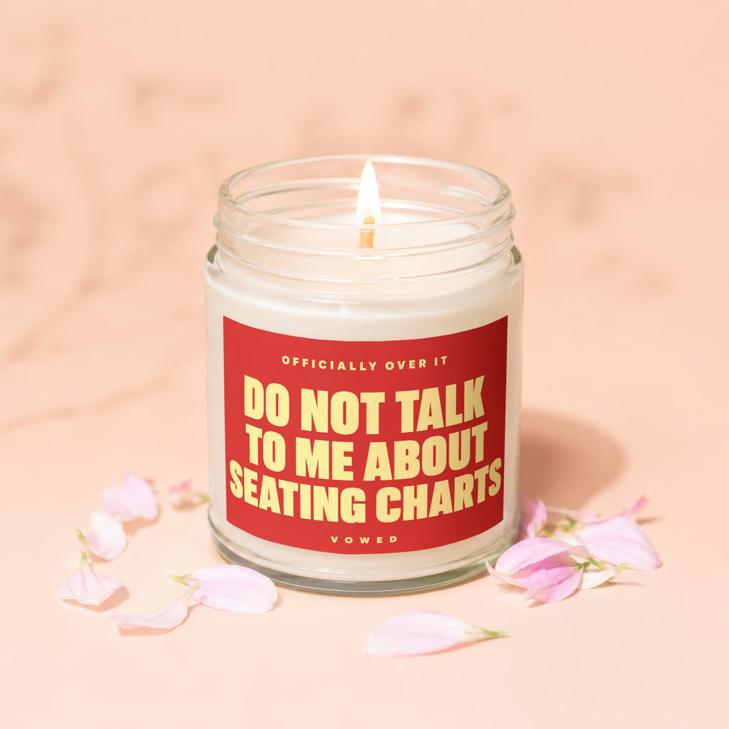 Lit candle in a jar with a red label reading "Do Not Talk to Me About Seating Charts."