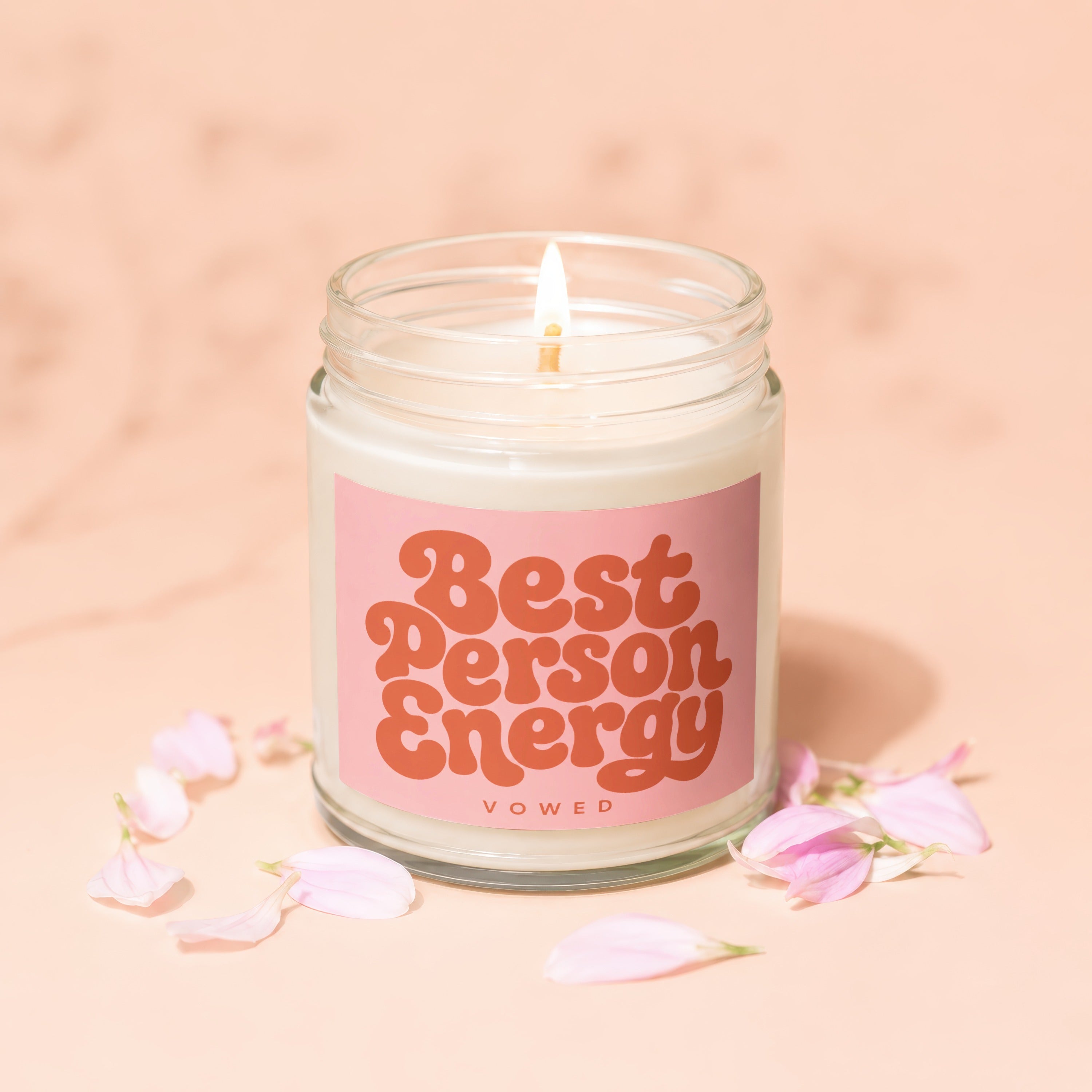 Candle with pink label reading "Best Person Energy VOWED" on marble.
