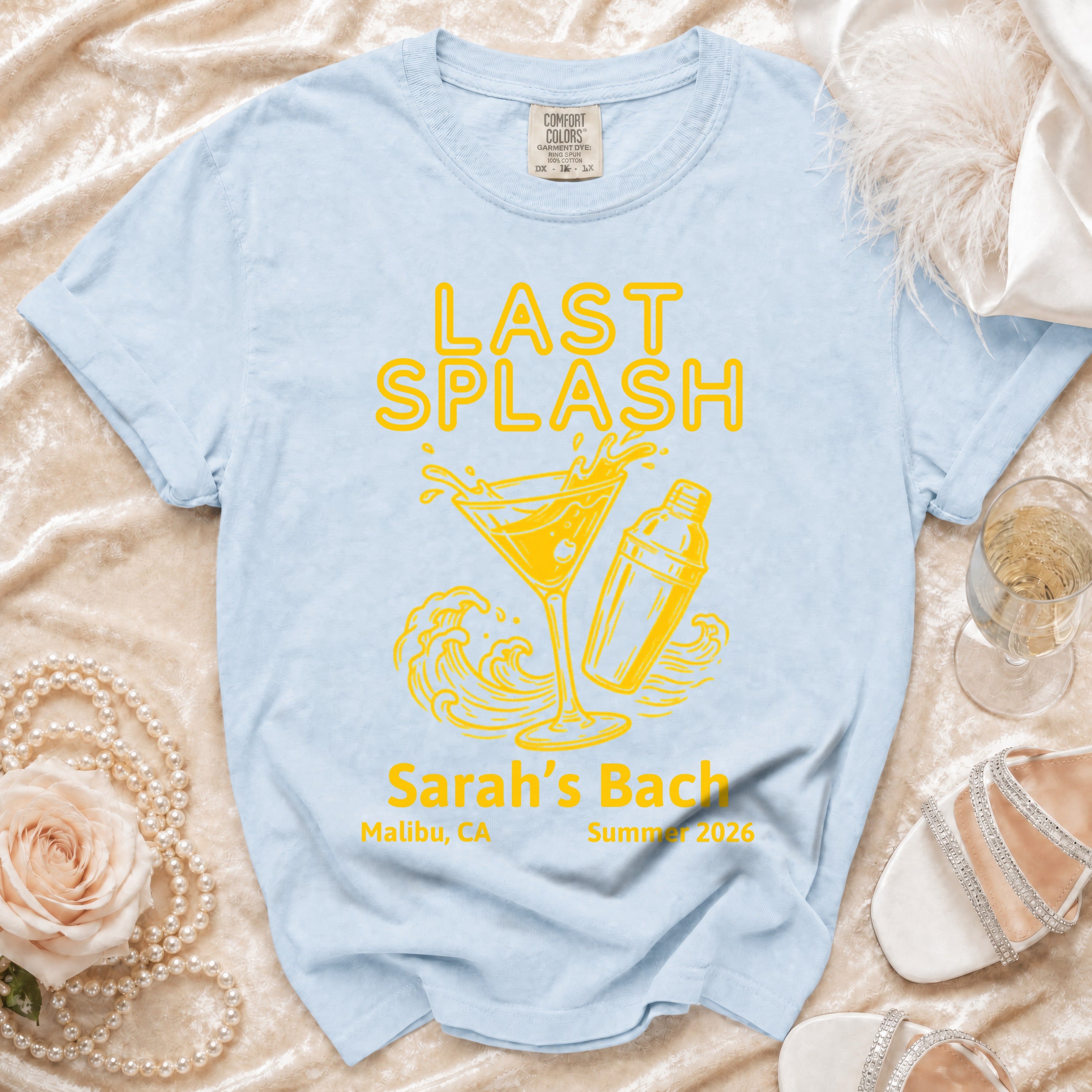 Light blue t-shirt with "LAST SPLASH" graphic and "Sarah's Bach" details.
