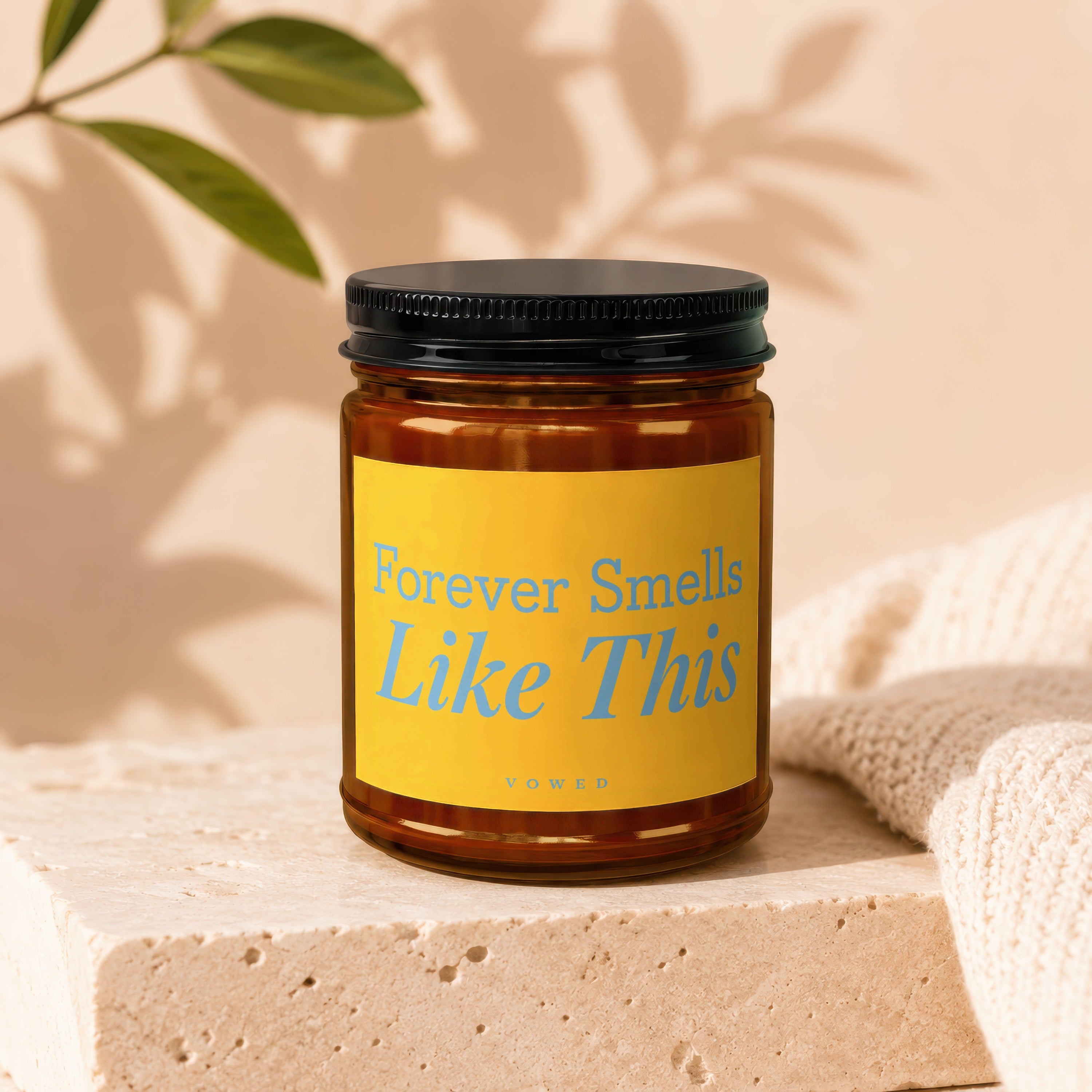 Amber candle in jar with yellow label reading "Forever Smells Like This" and "vowed."