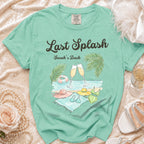 T-shirt with "Last Splash Sarah's Bach" text, palm trees, champagne, and beach accessories.