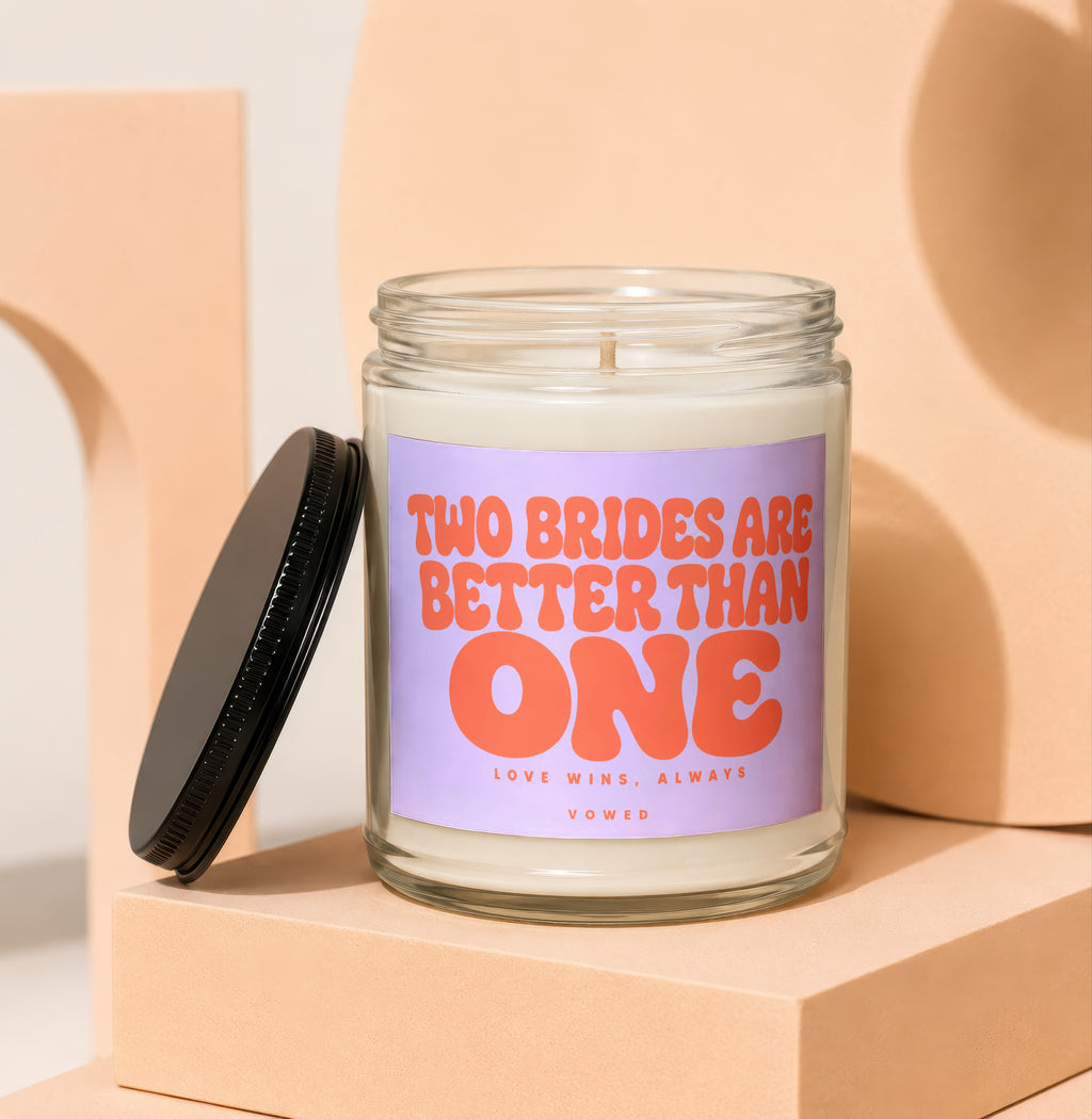 Candle with text "TWO BRIDES ARE BETTER THAN ONE" and "LOVE WINS, ALWAYS VOWED".