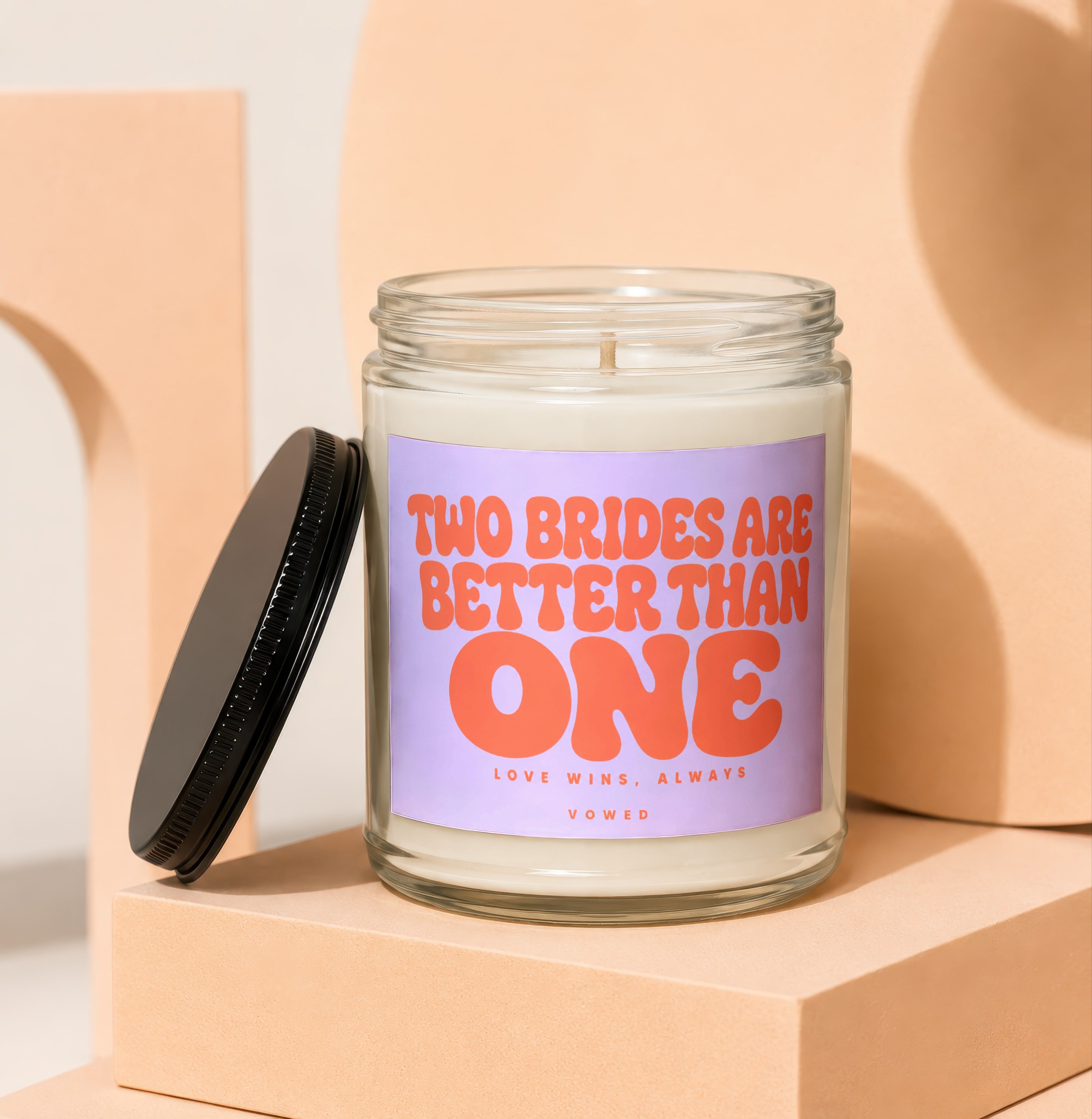 Candle with text "TWO BRIDES ARE BETTER THAN ONE" and "LOVE WINS, ALWAYS VOWED".