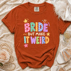 Orange t-shirt with "BRIDE BUT MAKE IT WEIRD" in colorful block letters.