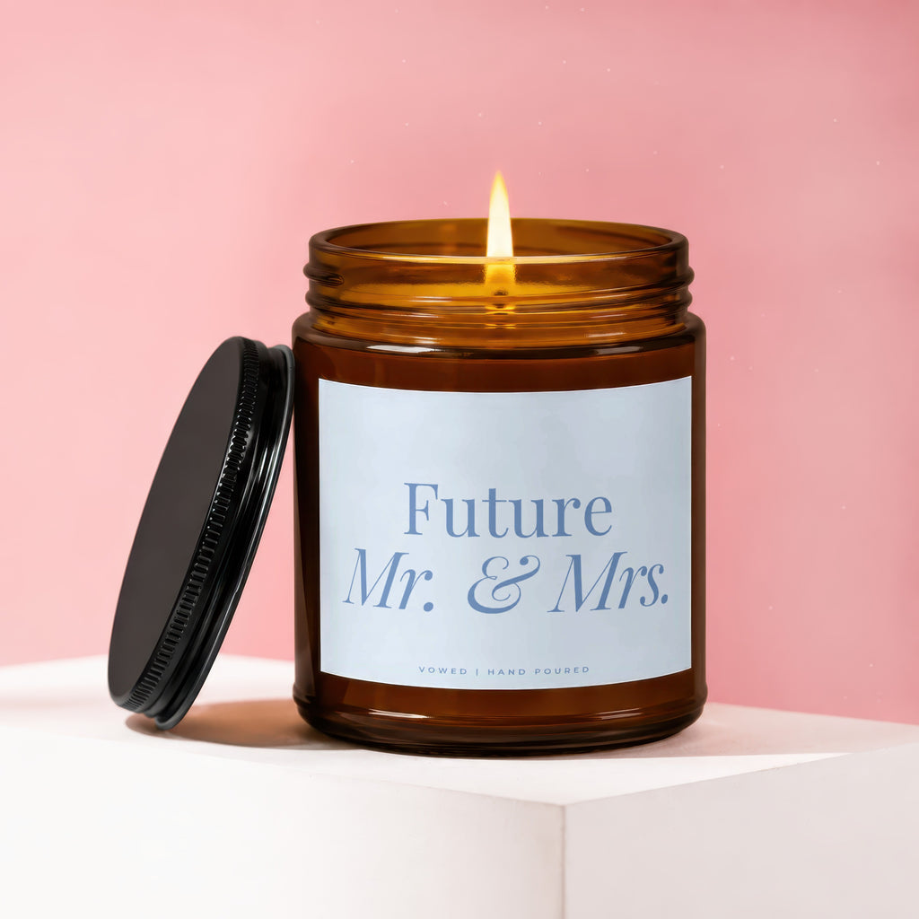 Amber glass candle burning with white label reading "Future Mr. & Mrs."