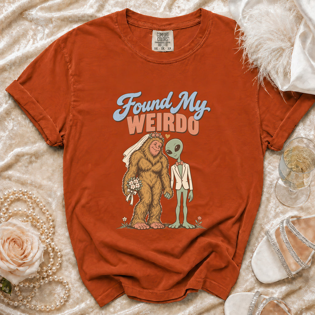 Orange t-shirt with Bigfoot bride and alien groom graphic saying "Found My Weirdo".