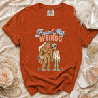 Orange t-shirt with Bigfoot bride and alien groom graphic saying "Found My Weirdo".