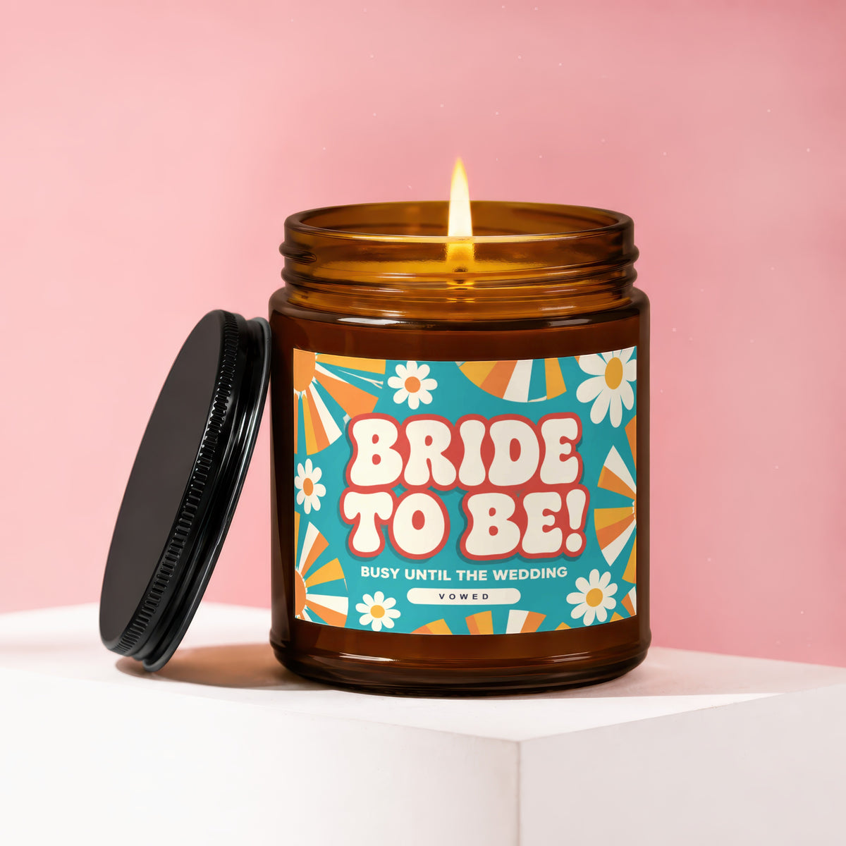 Amber candle with "Bride To Be! Busy Until the Wedding" label on pink background.
