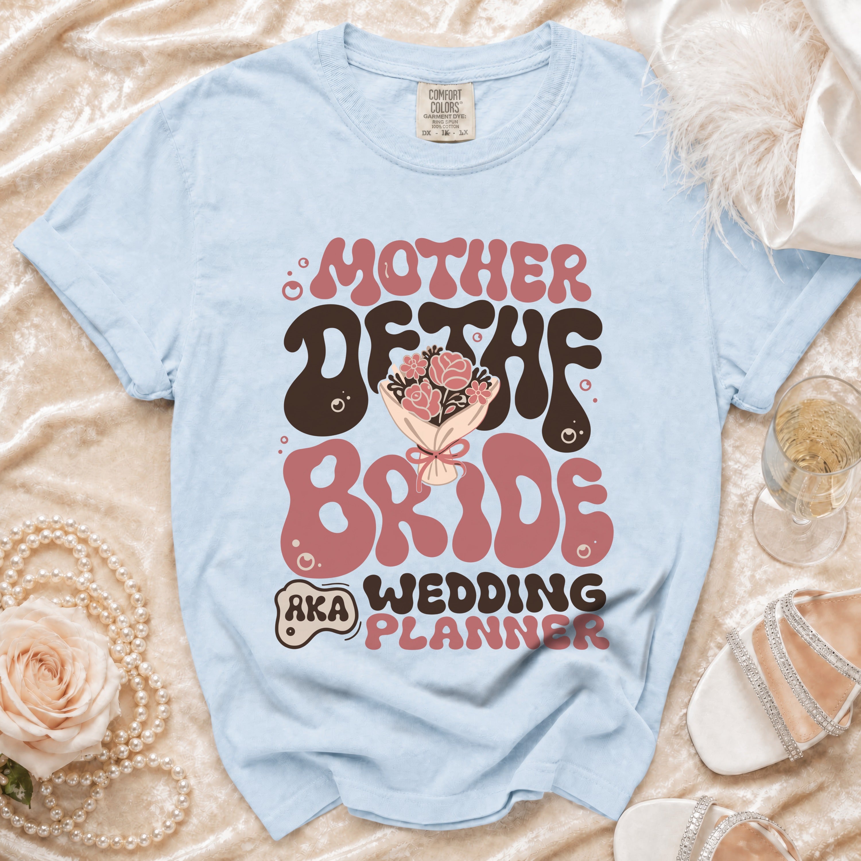 Light blue t-shirt with "Mother of the Bride AKA Wedding Planner" text.