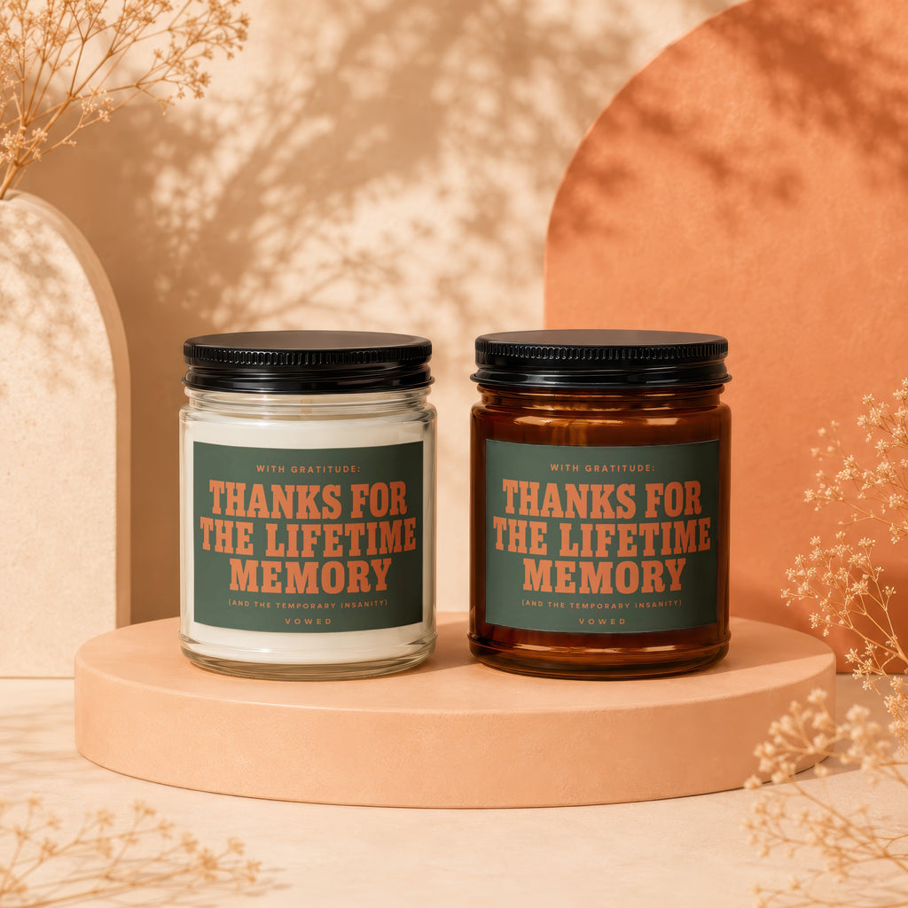 Two candles, one white and one amber, with labels saying "Thanks For The Lifetime Memory".