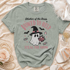 Green t-shirt with "Mother of the Bride Vowed to Help Steal the Show" graphic.