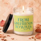 Candle with flame, lid off, labeled "From Girlfriends To Wives".