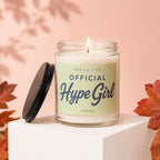 Lit candle in a jar with a light green label reading "Smells like Official Hype Girl".